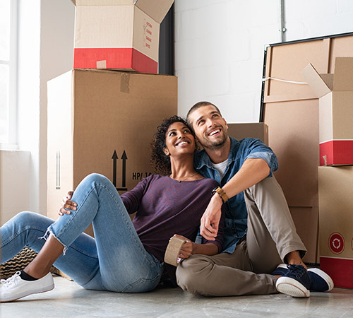 A couple surrounded by moving boxes